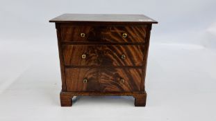 A MINIATURE MAHOGANY THREE DRAWER CHEST, THE DRAWER INTERIOR MARKED M.J. MORE - W 30.