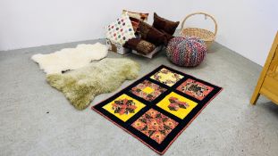 A MULTI COLOURED RAGCRAFT WOVEN POUFFE, A LARGE WICKER BASKET, 2 SHEEPSKIN RUGS, PATCHWORK THROW,