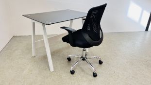 A MODERN DESIGNER HOME DESK WITH BLACK GLASS TOP ALONG WITH A MODERN ADJUSTABLE OFFICE CHAIR.