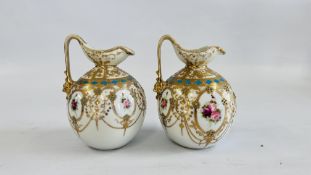 A PAIR OF VINTAGE ORNATE JUGS HANDPAINTED FLORAL DESIGN WITH APPLIED GILT DECORATION BEARING MAKERS