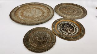 A GROUP OF 4 IRANIAN EMBOSSED COPPER TRAYS, THE LARGEST 59CM IN DIAMETER.