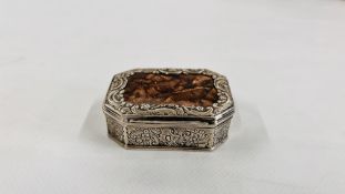 A CONTINENTAL WHITE METAL SNUFF BOX OF CANTED RECTANGULAR FROM THE LID INSET WITH A HARDSTONE