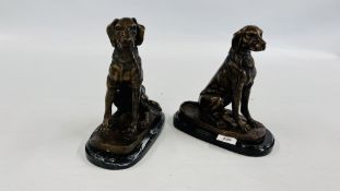 TWO CAST STUDIES OF SEATED DOGS ON MARBLE BASES, HEIGHT 25CM.