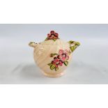 A CLARICE CLIFF NEWPORT POTTERY GLAZED TWO HANDLED POT AND COVER WITH RAISED FLOWERS ON A PALE PINK