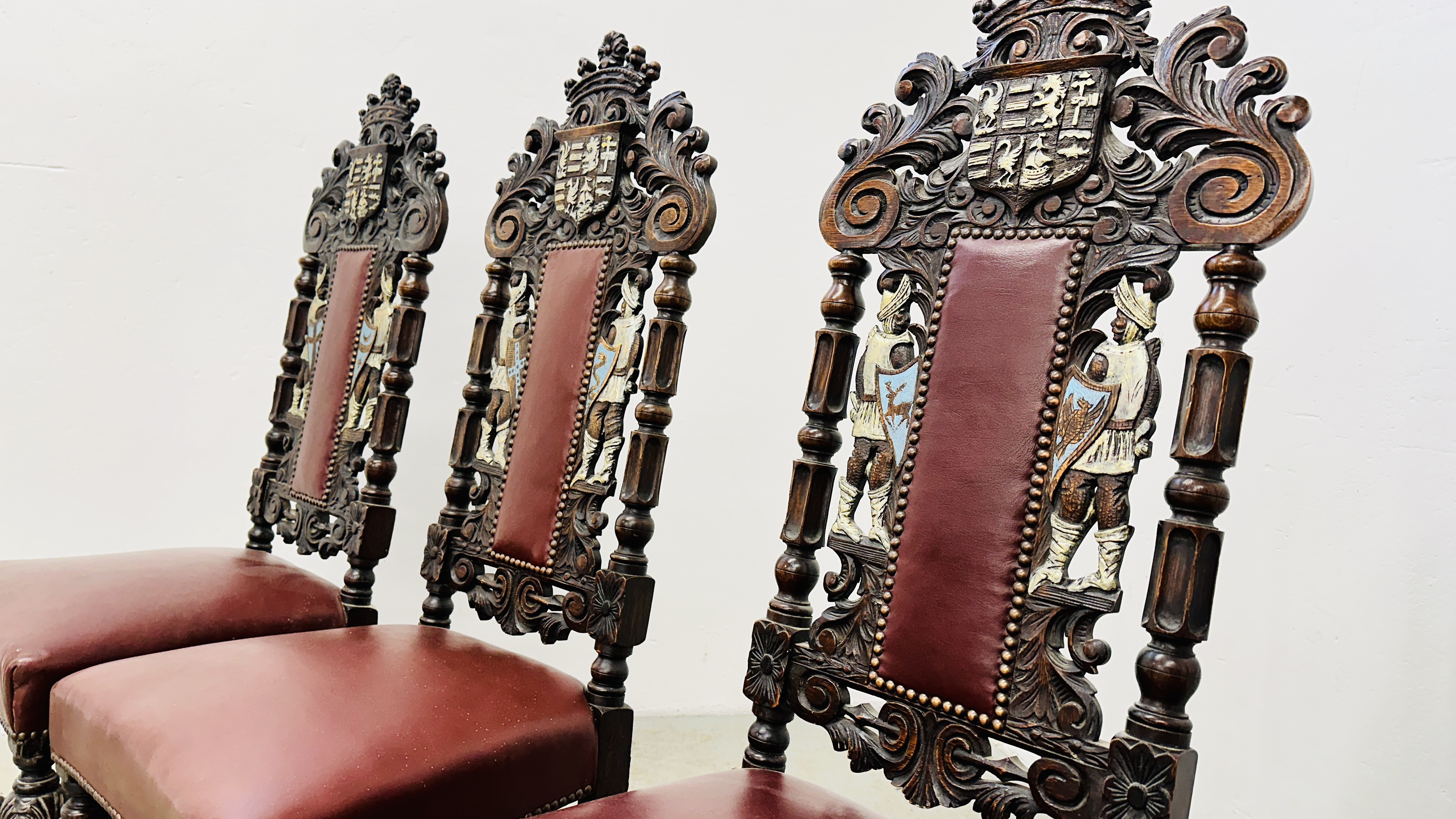 A SET OF 4 OAK FRAMED DINING CHAIRS WITH HEAVILY CARVED DETAIL BEARING CREST AND TWO KNIGHTS, - Image 11 of 12