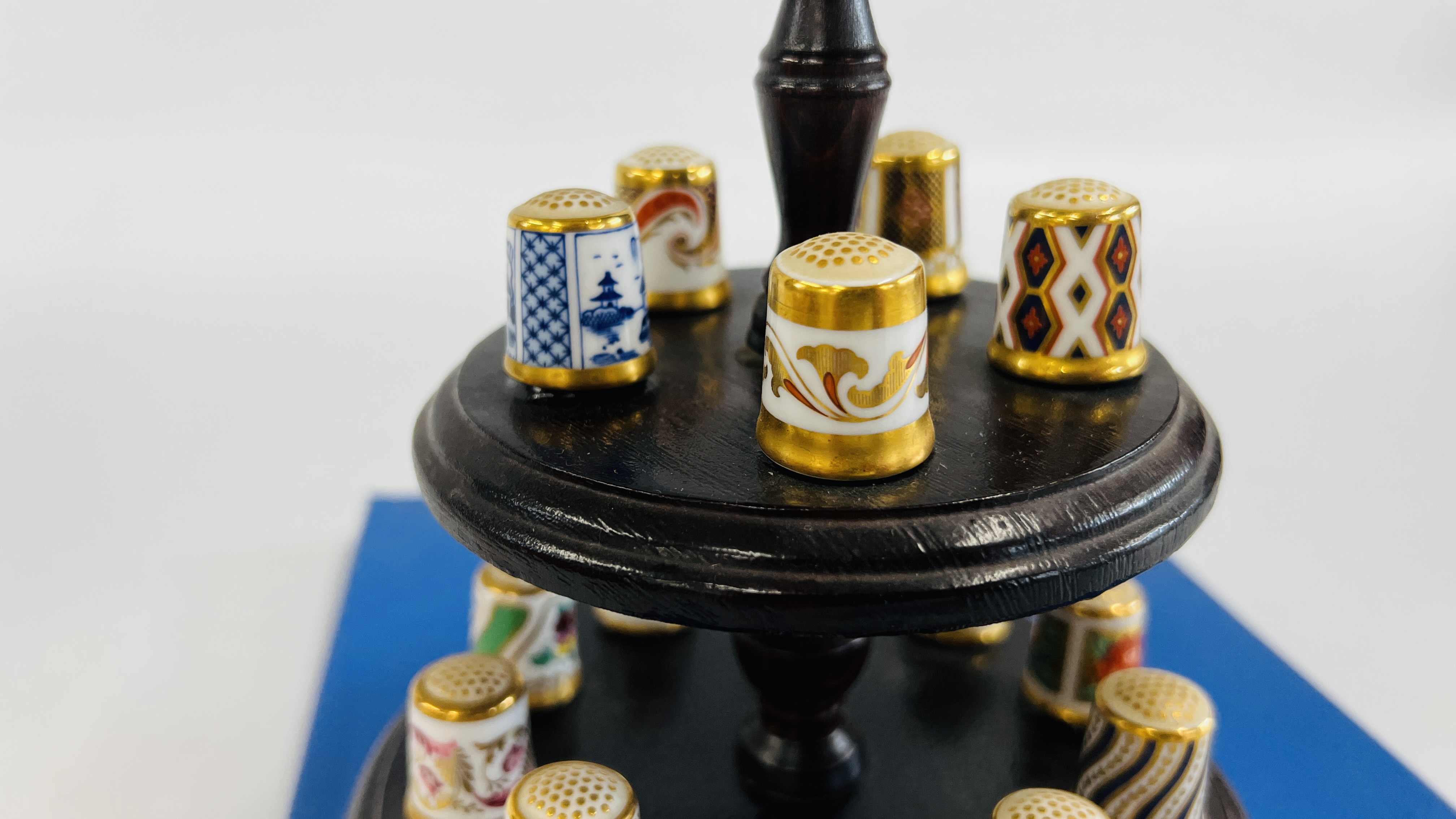A COLLECTION OF 15 ROYAL CROWN DERBY THIMBLES ON A THIMBLE STAND WITH A PIN CUSHION INSET ALONG - Image 5 of 9