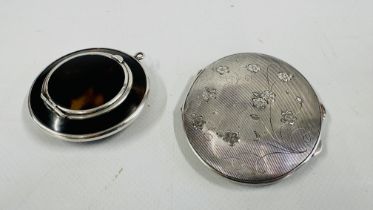 AN OVAL SILVER COMPACT DEPICTING AN ENGRAVED BUTTERFLY AND FLORAL DESIGN - L8 X W 6.