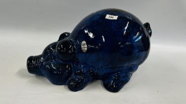 A LARGE BLUE GLAZED STUDIO POTTERY PIG, L 47CM X H 29CM.