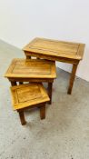 A NEST OF THREE MODERN SOLID LIGHT OAK TABLES.