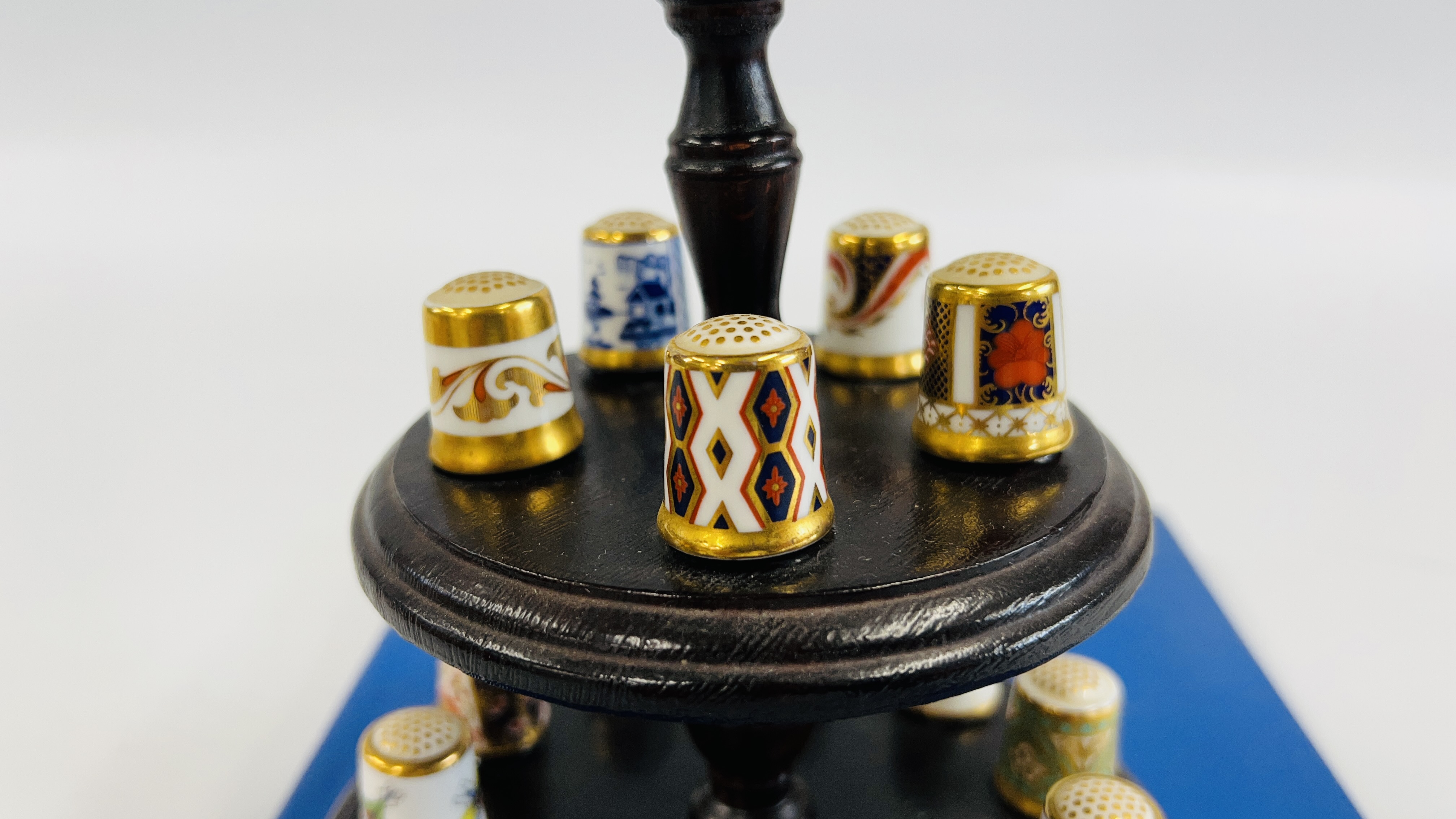 A COLLECTION OF 15 ROYAL CROWN DERBY THIMBLES ON A THIMBLE STAND WITH A PIN CUSHION INSET ALONG - Image 7 of 9