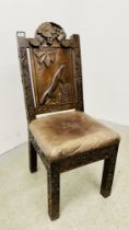 A VINTAGE OAK FRAMED HIGH BACK HALL CHAIR WITH CARVED SCENE SURROUNDED BY A GRAPEVINE WITH LEATHER