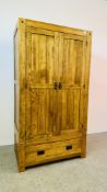 A GOOD QUALITY MODERN SOLID LIGHT OAK TWO DOOR WARDROBE ON SINGLE DRAWER BASE.