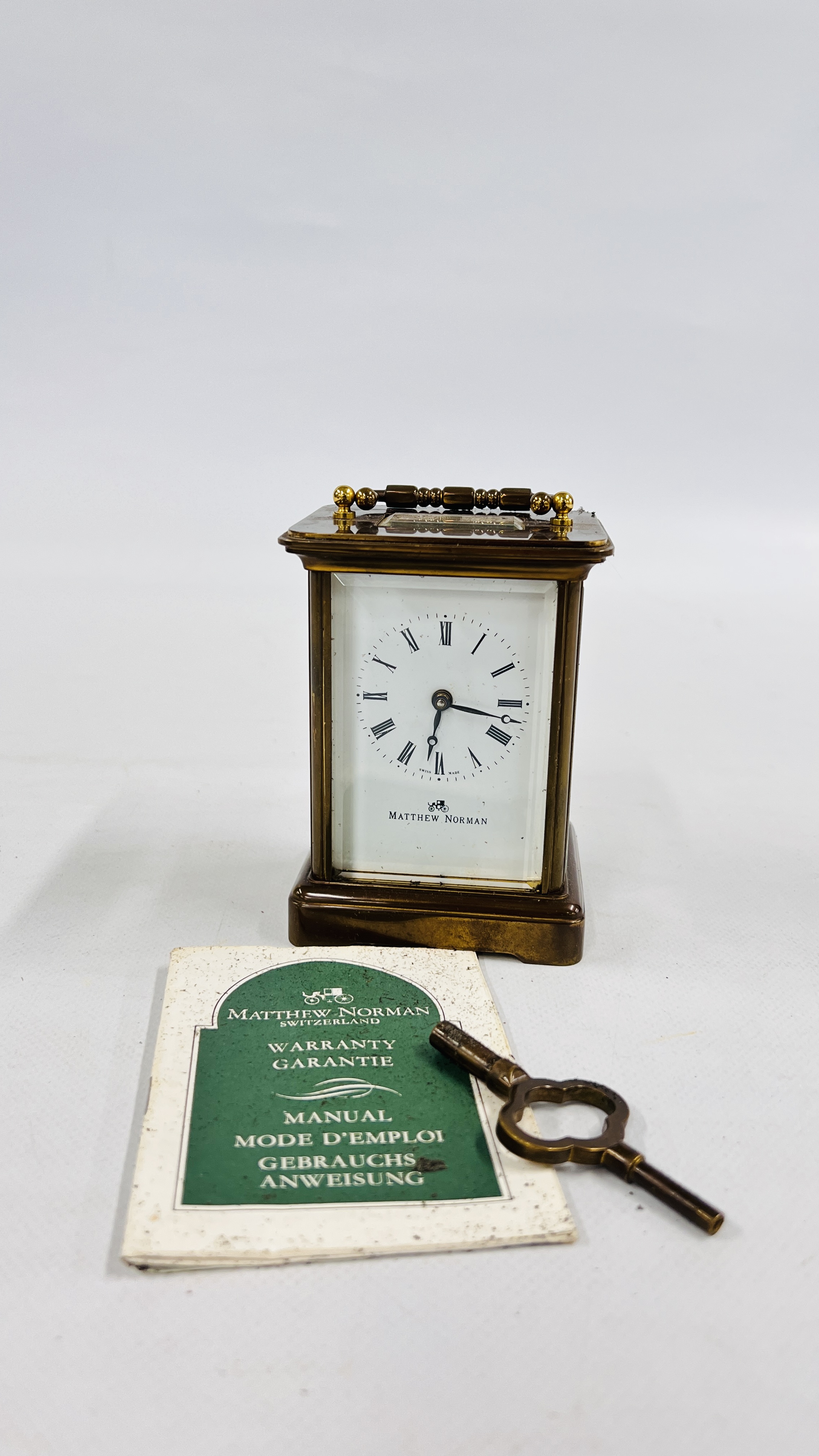 A MATTHEW NORMAN BRASS CASED CARRIAGE CLOCK WITH ORIGINAL BOX.