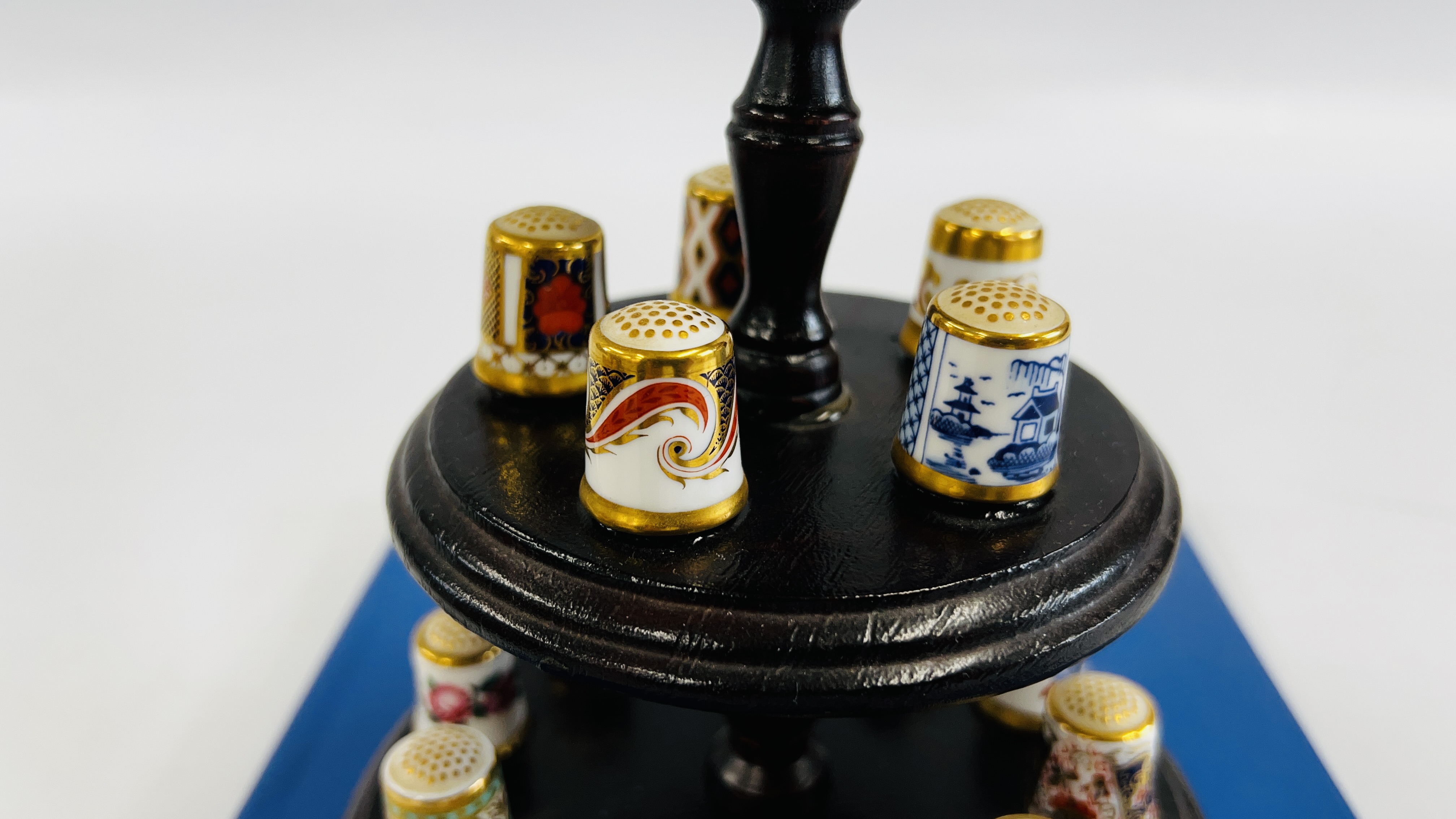 A COLLECTION OF 15 ROYAL CROWN DERBY THIMBLES ON A THIMBLE STAND WITH A PIN CUSHION INSET ALONG - Image 3 of 9