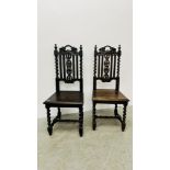 A PAIR OF ANTIQUE OAK HALL CHAIRS WITH CARVED DETAIL AND BARLEY TWIST SUPPORTS.