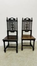 A PAIR OF ANTIQUE OAK HALL CHAIRS WITH CARVED DETAIL AND BARLEY TWIST SUPPORTS.