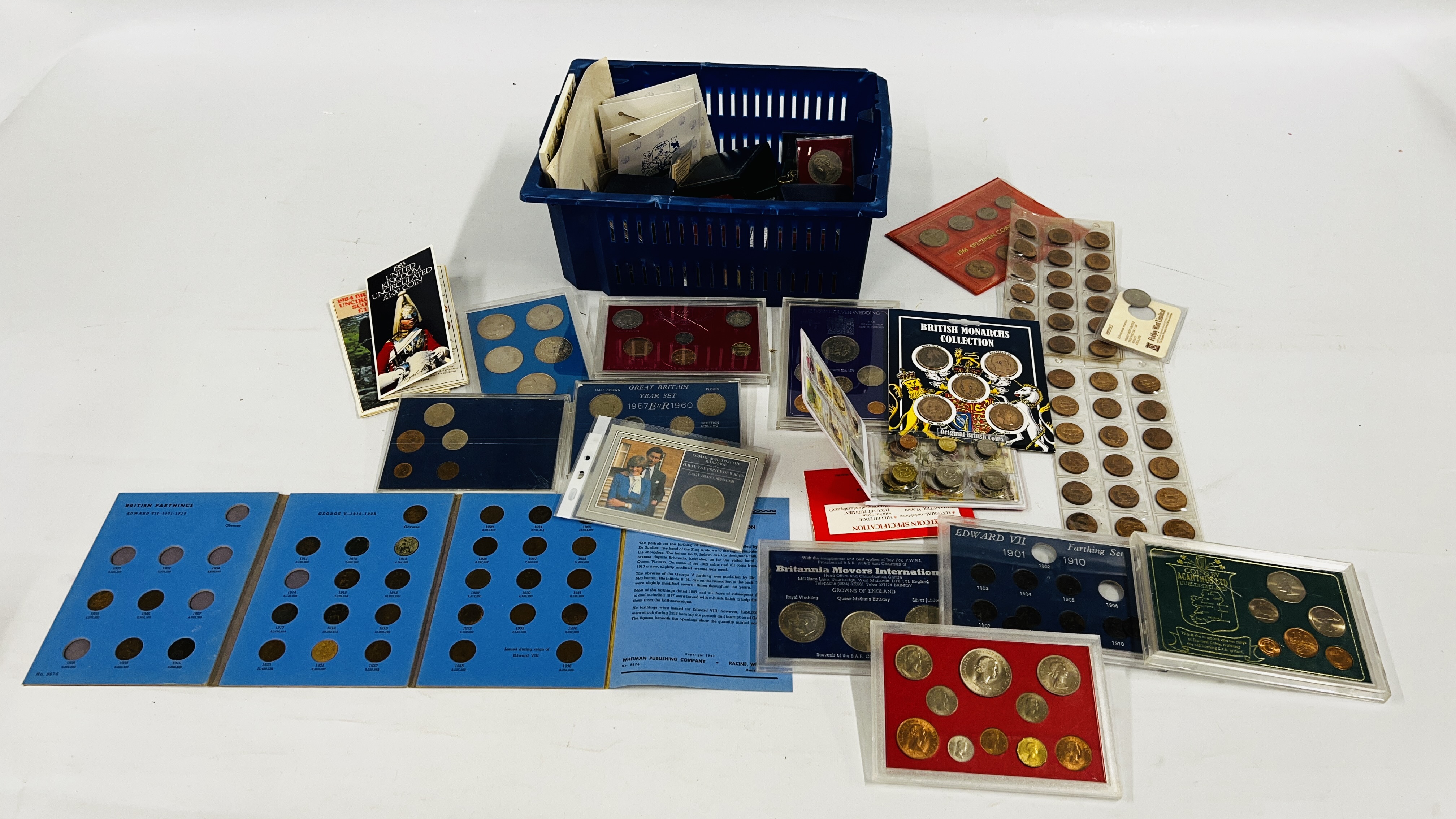 A BLUE TUB CONTAINING QUANTITY OF COIN SETS AND MEDALLIONS.