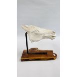 AN IMPRESSIVE PLASTER HORSE HEAD SCULPTURE SUSPENDED ON A BRASS BRACKET AND MOUNTED ON A NATURAL