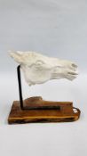 AN IMPRESSIVE PLASTER HORSE HEAD SCULPTURE SUSPENDED ON A BRASS BRACKET AND MOUNTED ON A NATURAL