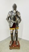 A REPRODUCTION KNIGHT'S SUIT OF ARMOUR COMMISSIONED BY CHAPMAN RADFORD ON DISPLAY STAND,
