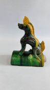 A CHINESE STYLE CERAMIC RIDGE TILE DEPICTING A MYTHICAL HORSE FINISHED IN A VIVID GREEN AND YELLOW