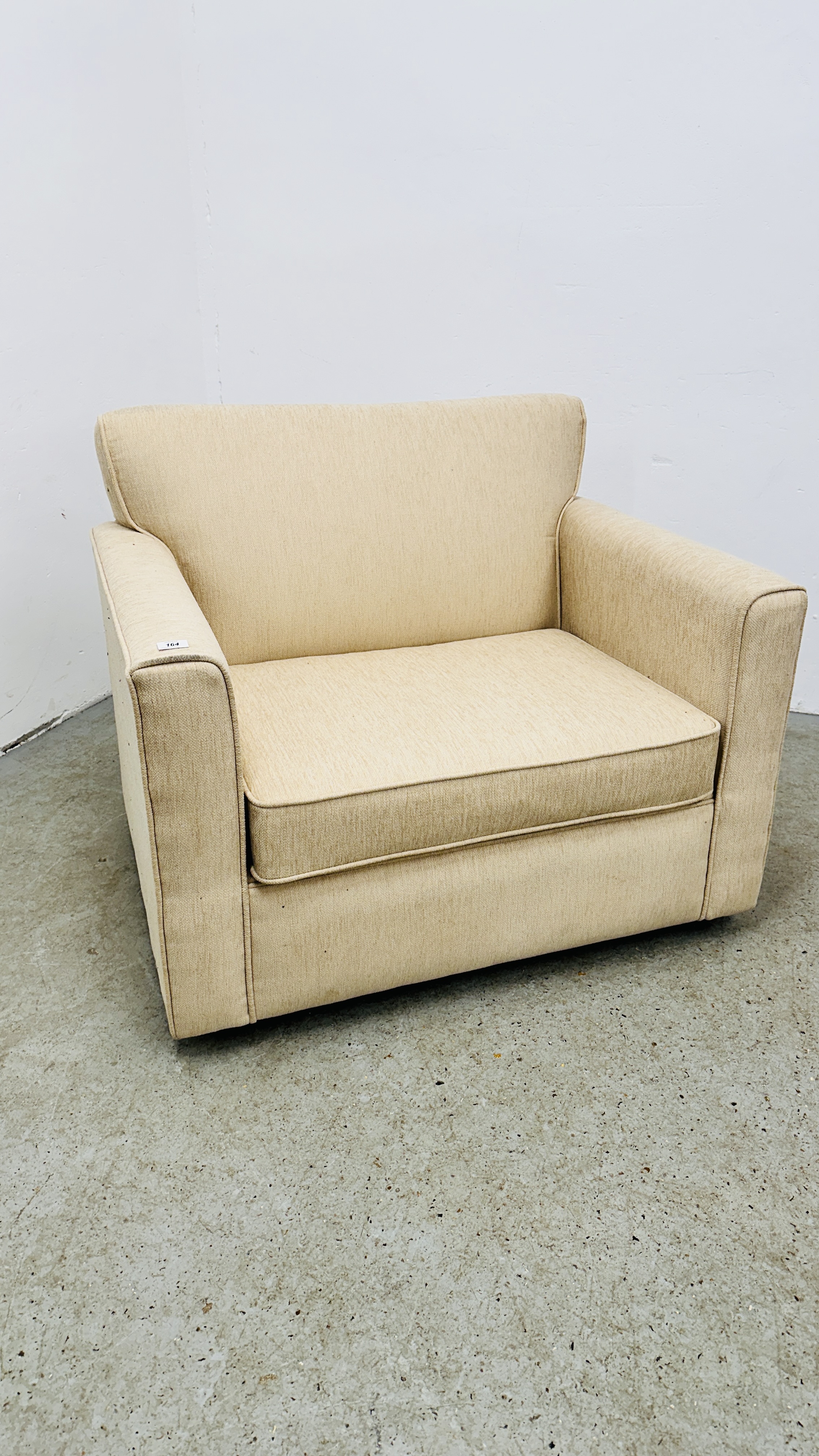 CREAM UPHOLSTERED ARM CHAIR / SOFA BED.