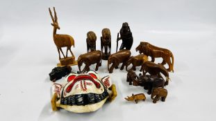 A GROUP OF CARVED AFRICAN BUSTS AND ANIMALS ALONG WITH AN EASTERN PAINTED MASK.