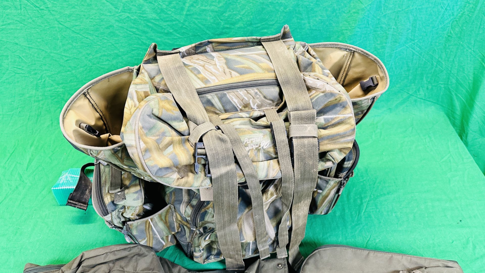 NASH CAMOUFLAGE MULTI POCKET BACK PACK ALONG WITH T F GEAR CAMOUFLAGE JACKET SIZE L AND ROD BAG. - Image 4 of 11