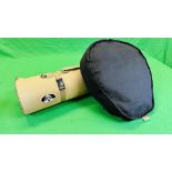 A BLACK CANVAS SHOOTING CUSHION ALONG WITH A GREEN ROLL OUT SHOOTING MAT.