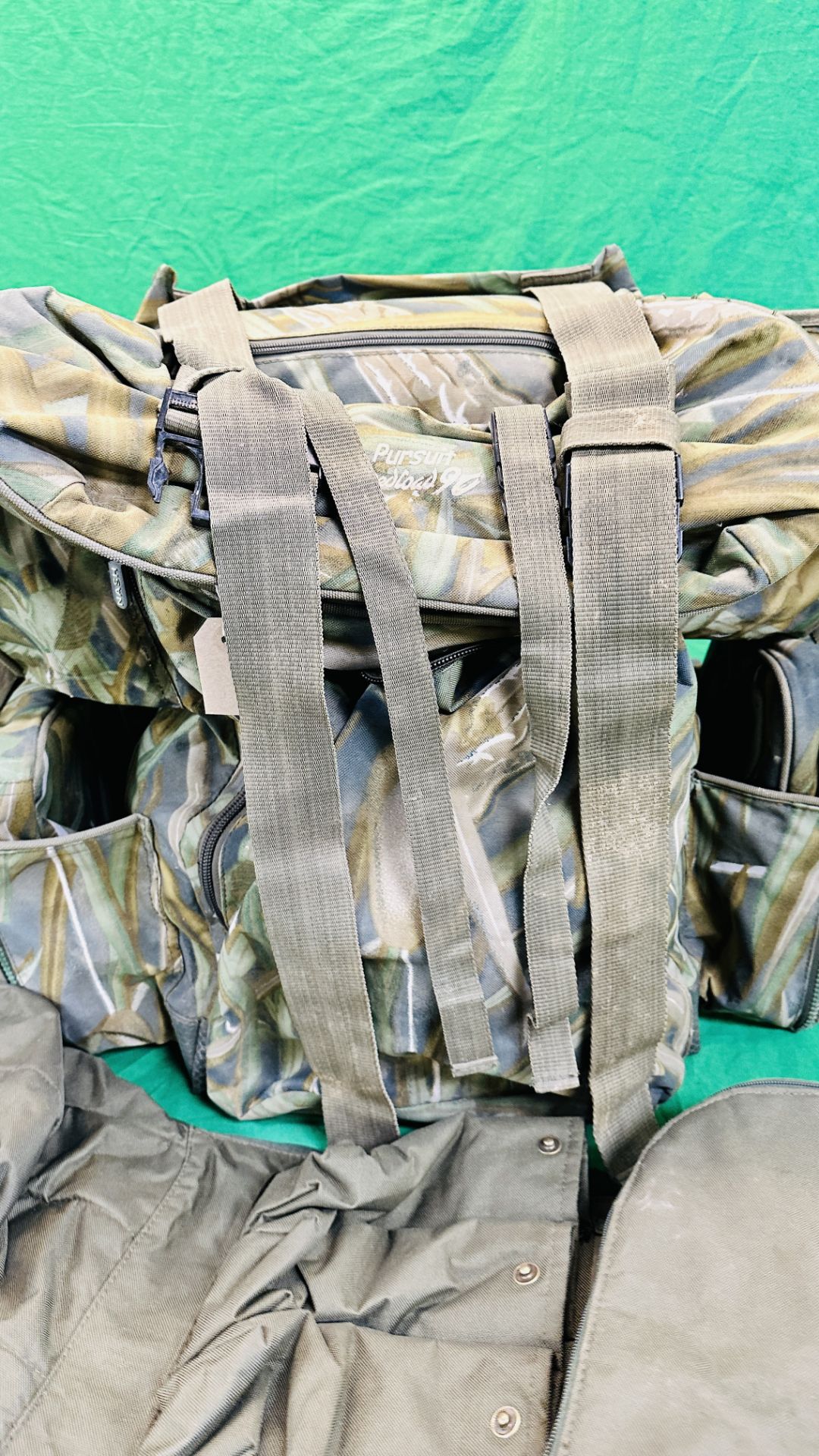 NASH CAMOUFLAGE MULTI POCKET BACK PACK ALONG WITH T F GEAR CAMOUFLAGE JACKET SIZE L AND ROD BAG. - Image 6 of 11