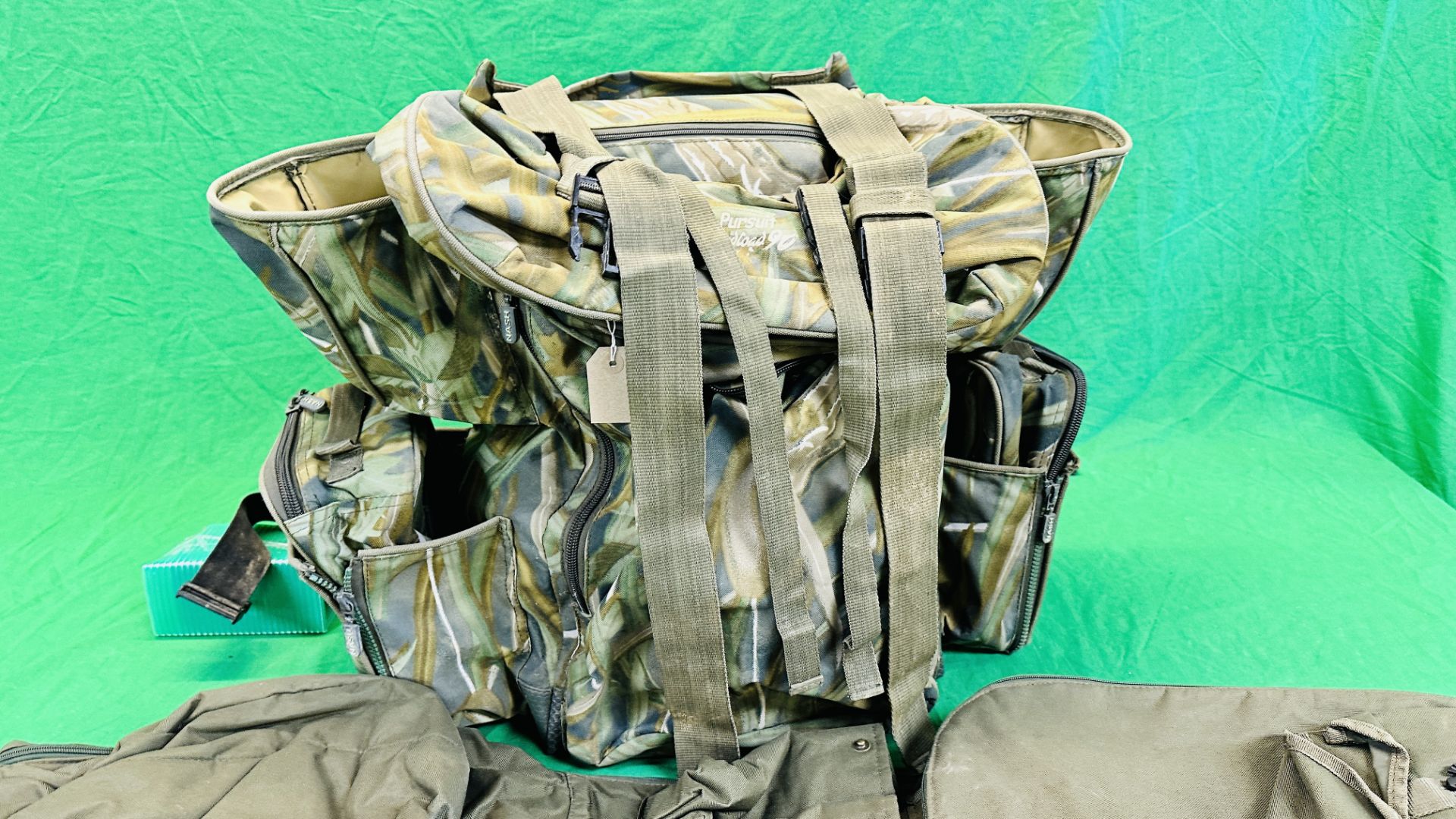 NASH CAMOUFLAGE MULTI POCKET BACK PACK ALONG WITH T F GEAR CAMOUFLAGE JACKET SIZE L AND ROD BAG. - Image 3 of 11