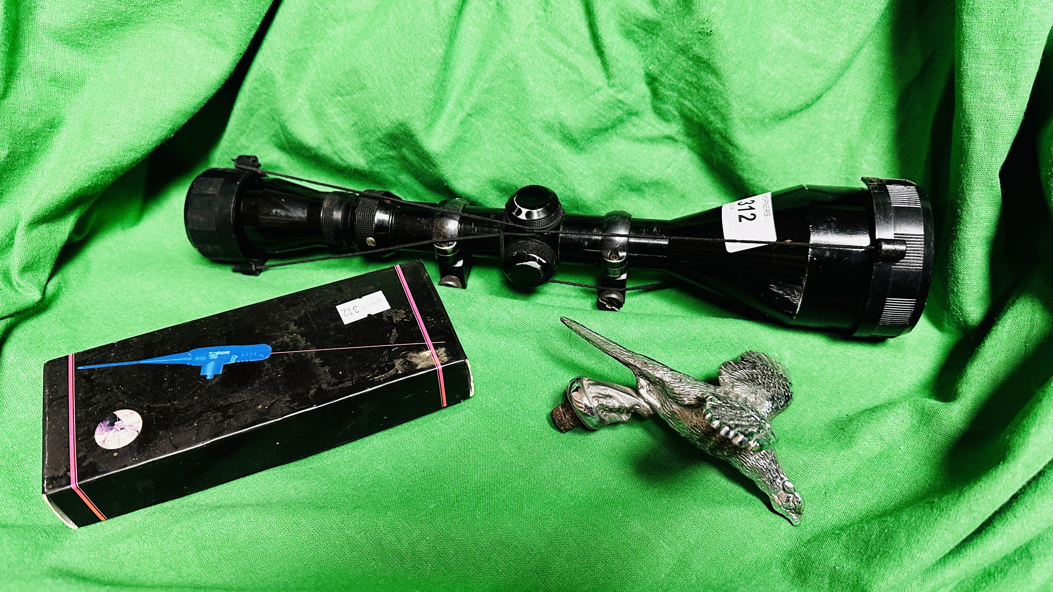 A RIFLE SCOPE, MOUNTS AND LASER SIGHT PLUS A CAR MASCOT OF A PHEASANT IN FLIGHT.