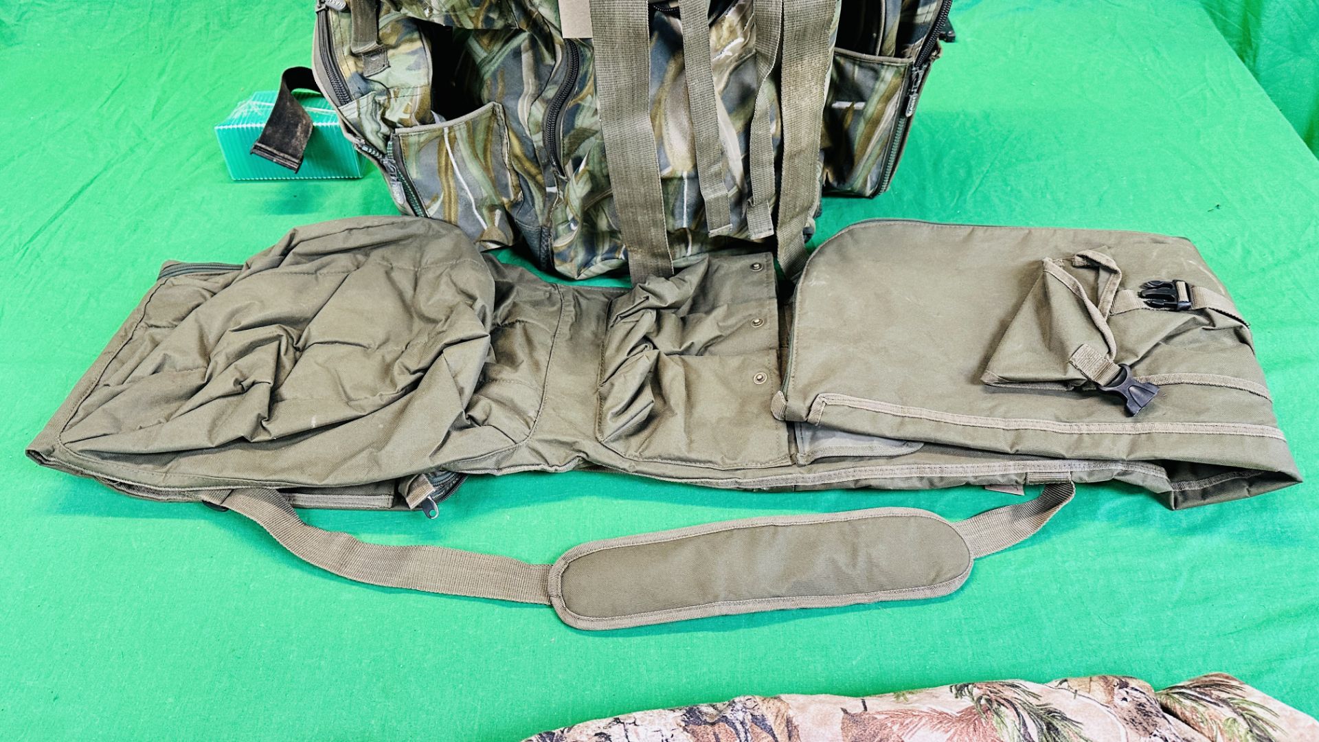 NASH CAMOUFLAGE MULTI POCKET BACK PACK ALONG WITH T F GEAR CAMOUFLAGE JACKET SIZE L AND ROD BAG. - Image 8 of 11