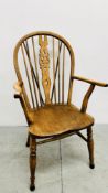 A VINTAGE OAK WHEELED BACK ELBOW CHAIR.