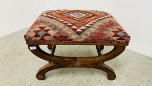 A MAHOGANY CROSS STRETCHER STOOL WITH UPHOLSTERED PATTERN CUSHION.