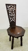 AN OCTAGONAL SEATED SOLID OAK CARVED CHAIR, SIGNS OF REPAIR.