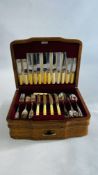 AN ART DECO OAK CASED CANTEEN CONTAINING A QUANTITY OF NON MATCHING FLATWARE W 40 X D 31 X H 15.5CM.