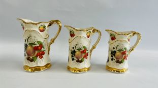 THREE GRADUATED REPRODUCTION JUGS DECORATED WITH FRUIT.