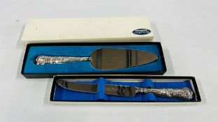 A BOXED STERLING SILVER HANDLED CAKE SLICE ALONG WITH A BOXED STERLING SILVER HANDLED KNIFE.