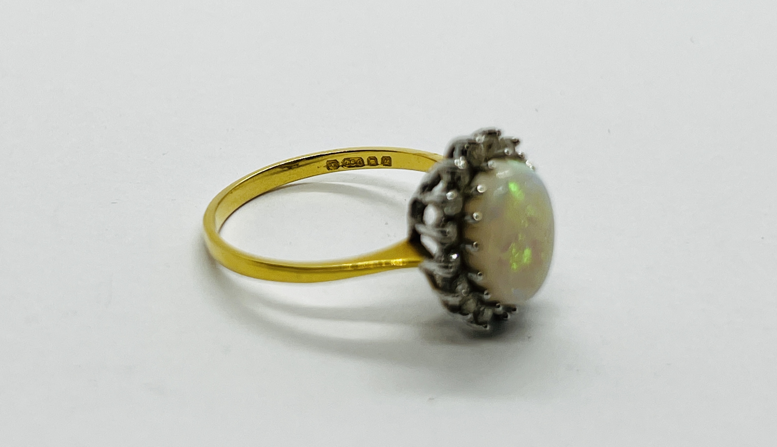 AN 18CT GOLD RING SET WITH A CENTRAL OVAL OPAL SURROUNDED BY DIAMONDS. - Image 5 of 12