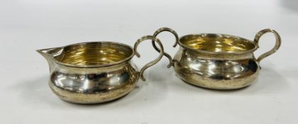 A SILVER CREAM AND SUGAR BOWL OF MATCHING DESIGN