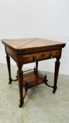 EDWARDIAN OAK ENVELOPE TOP CARD TABLE WITH LOWER GALLERIED TIER AND GREEN BASE.
