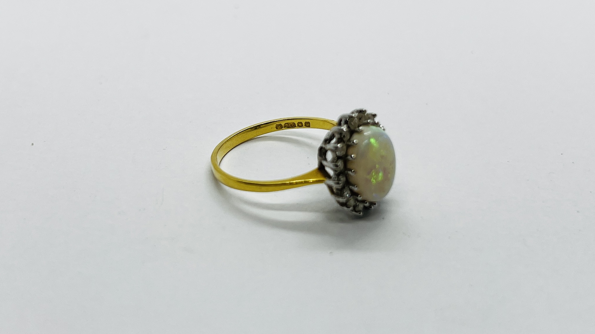 AN 18CT GOLD RING SET WITH A CENTRAL OVAL OPAL SURROUNDED BY DIAMONDS. - Image 4 of 12