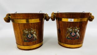 A PAIR OF ANTIQUE OAK AND BRASS BOUND NAVAL FIRE BUCKETS WITH ROPE AND LEATHER BOUND HANDLE,