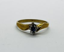 A 9CT GOLD LADIES RING SET WITH A CENTRAL SAPPHIRE AND SMALLER DIAMONDS.