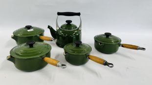 A GROUP OF FOUR GRADUATED LE CREUSET CAST IRON PANS IN GREEN AND LE CREUSET KETTLE IN GREEN.