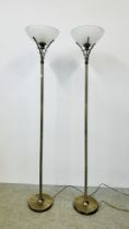 A PAIR OF DESIGNER BRASS FINISH STANDARD LAMPS WITH FROSTED GLASS SHADES - SOLD AS SEEN.