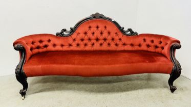 A VICTORIAN MAHOGANY FRAMED HUMP BACK SOFA IN RED BUTTON BACK VELOUR - L 210CM.