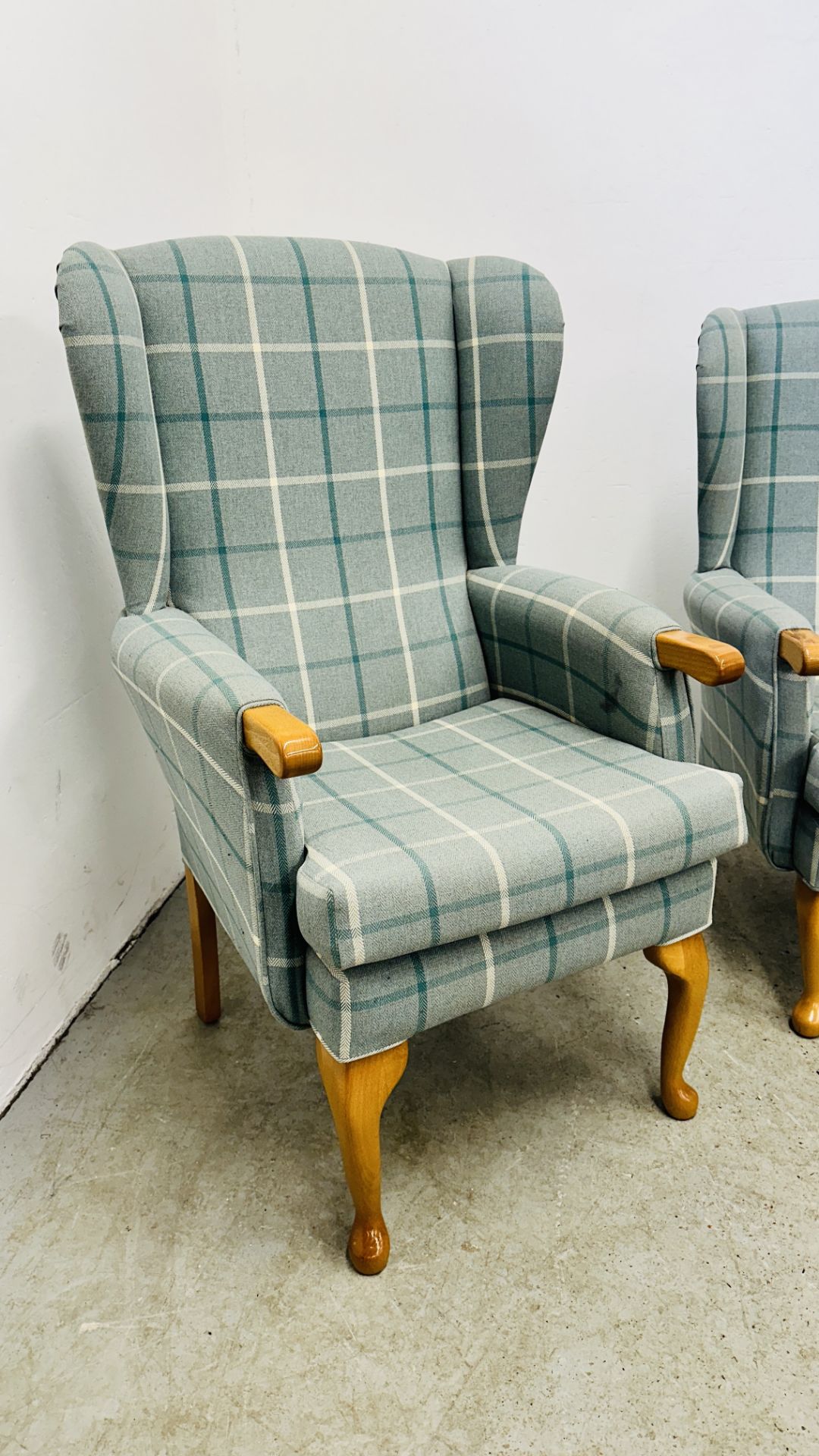 A HIS & HERS SET OF MODERN BLUE CHECKERED UPHOLSTERED BEECH WOOD WING BACK CHAIRS. - Image 13 of 17