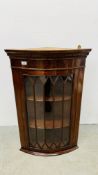 A REPRODUCTION BOW FRONT CORNER CABINET.